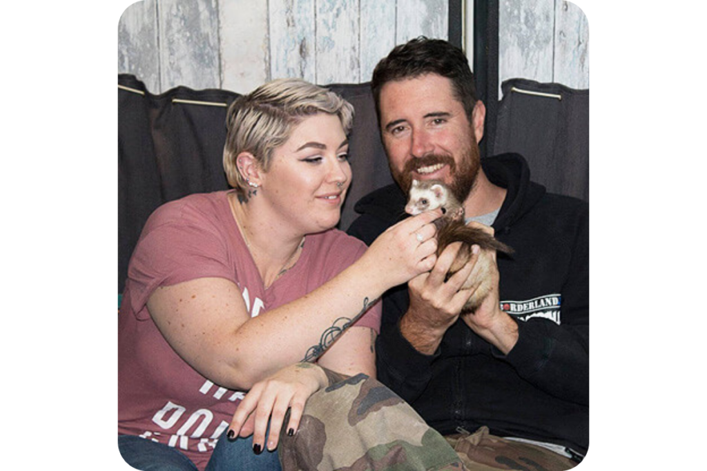 A photo of Elle and Craig with their beloved ferret. 